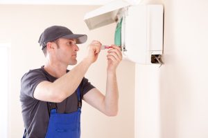 HVAC-technician-repairing-a-ductless-air-handler