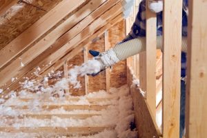 insulation-installer-blowing-insulation-into-an-attic-space